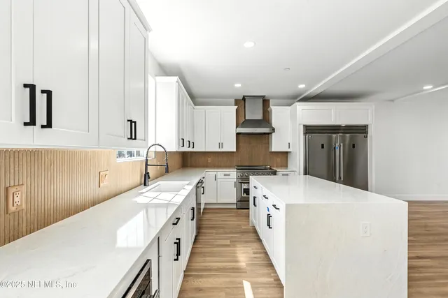 an empty room with wooden floor and a ceiling fan