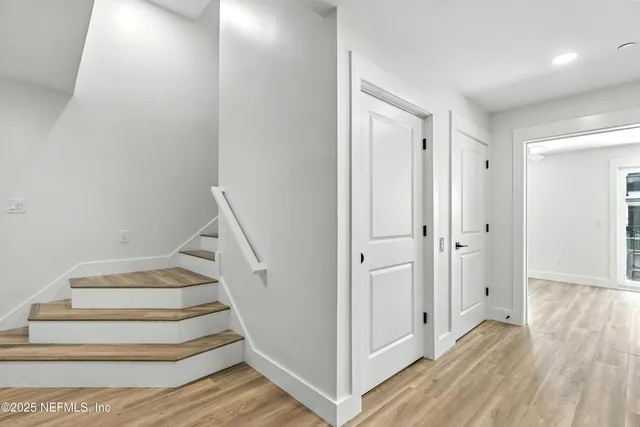 an aerial view of residential houses with outdoor space and parking