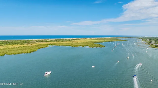 a view of a house with a barbeque and wooden fence
