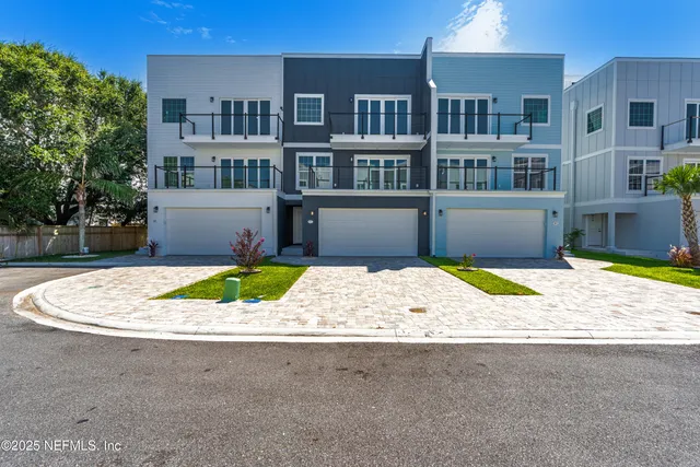 an aerial view of residential houses with outdoor space