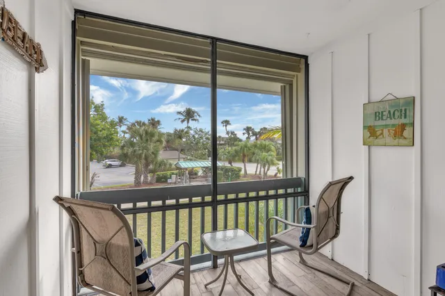 a view of a balcony with chair and a potted plant