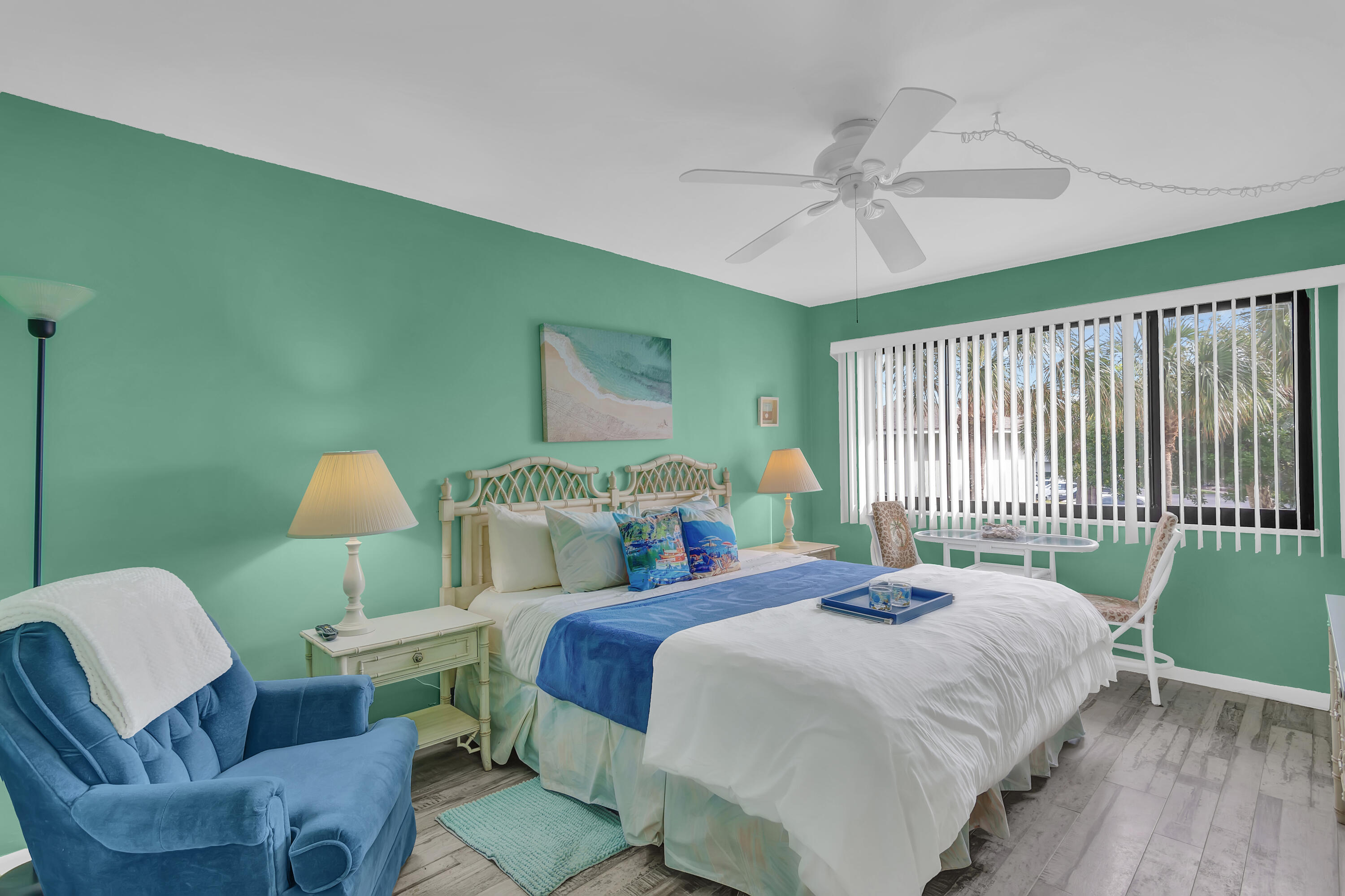2400 South Ocean Drive, Unit 1122 Fort Pierce, FL 34949 - Photo 14 of 18 a bedroom with a bed a chandelier and a window