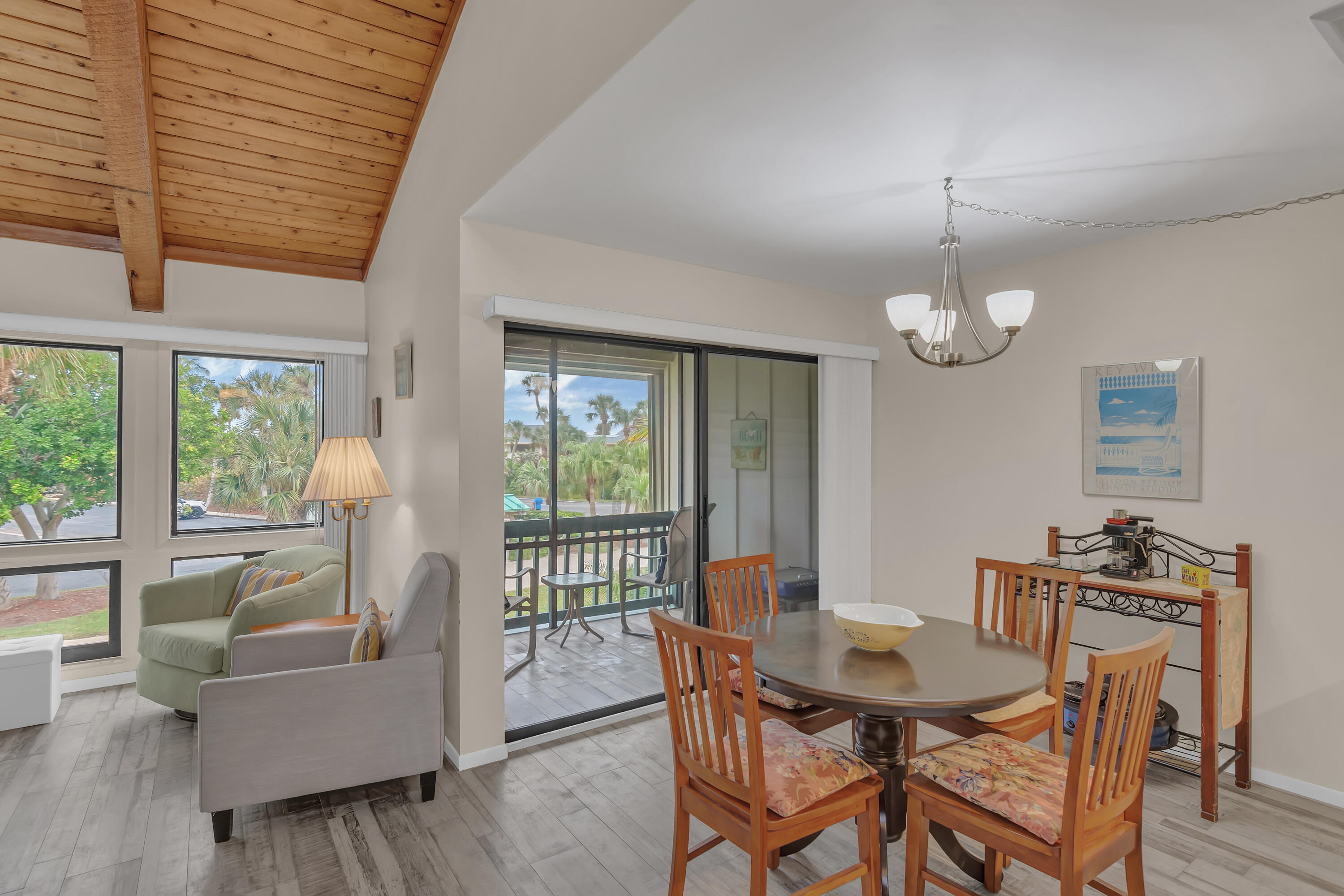 2400 South Ocean Drive, Unit 1122 Fort Pierce, FL 34949 - Photo 5 of 18 a view of a dining room with furniture a chandelier and wooden floor