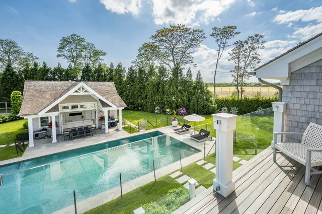 an aerial view of a house with swimming pool garden view and a patio