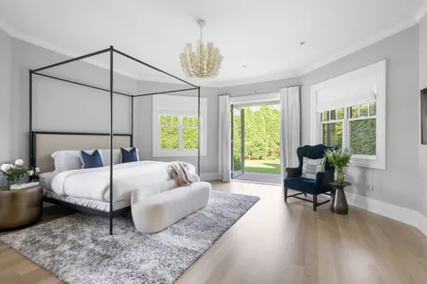 a bed room with a bed and a chair