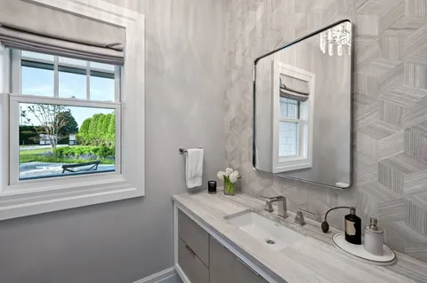 a bathroom with a sink vanity and a mirror