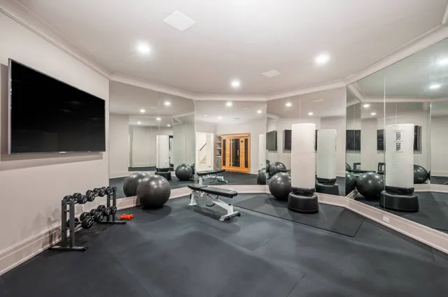 a room with gym equipment and a large mirror