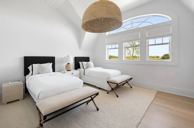 a bedroom with a bed and chandelier