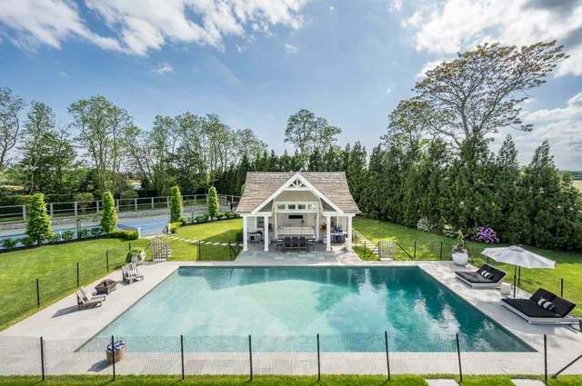 a view of a house with swimming pool and yard