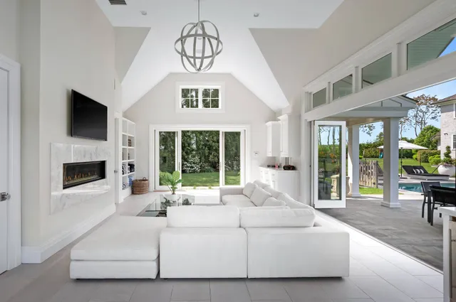 a living room with furniture a fireplace and a flat screen tv