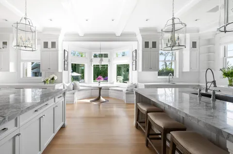 a large kitchen with granite countertop a sink and a counter top space