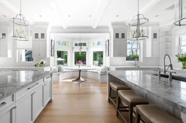 a large kitchen with granite countertop a sink and a counter top space
