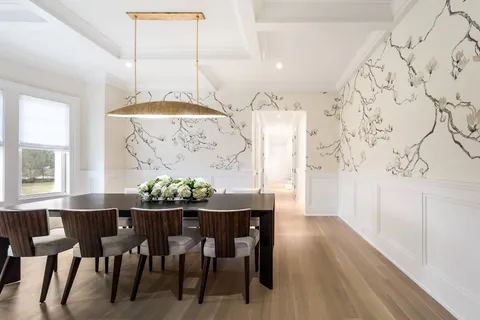 a view of a dining room with furniture and chandelier