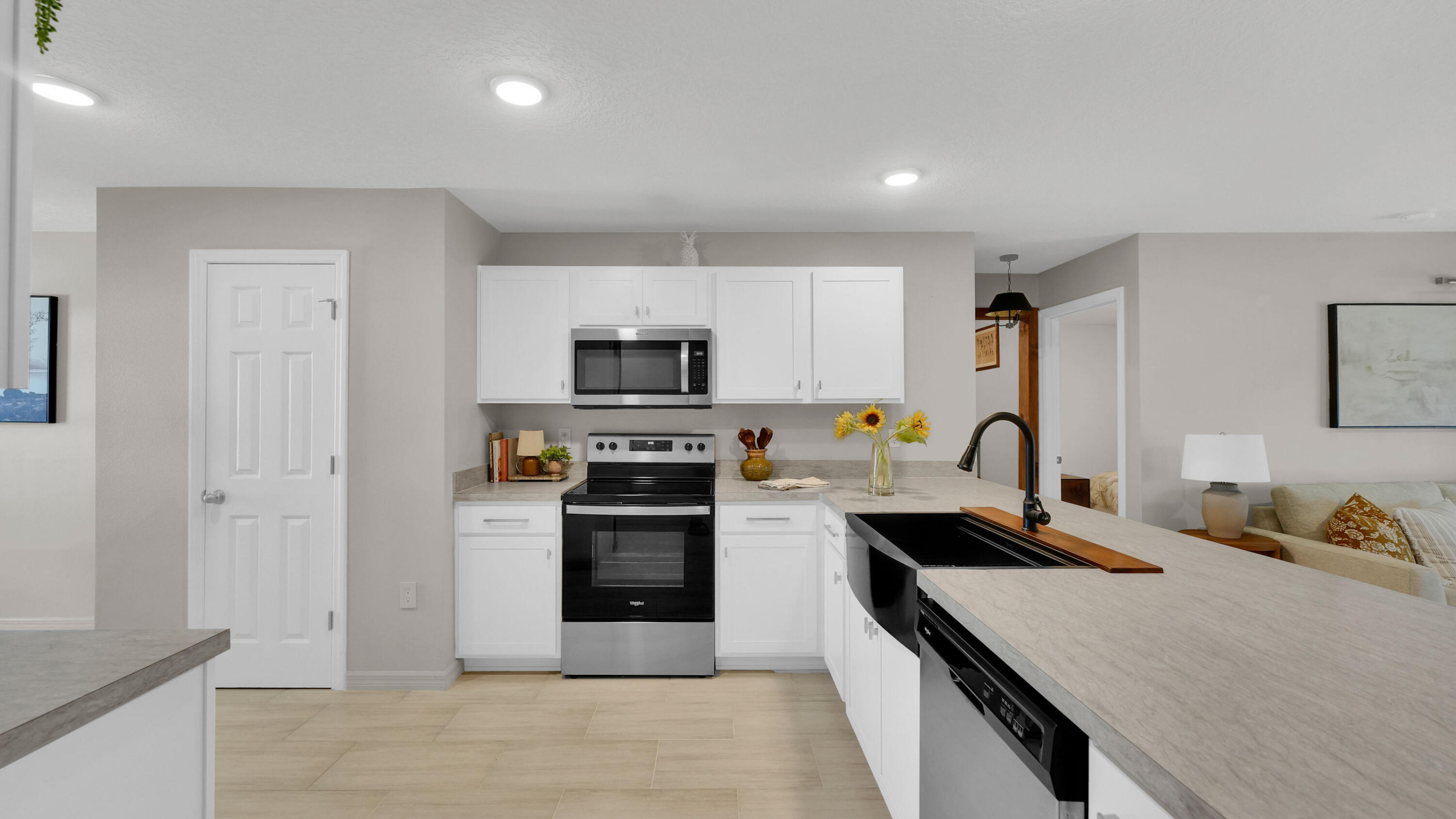 1382 Southwest Becker Road Port St. Lucie, FL 34953 - Photo 20 of 56 a large kitchen with a refrigerator stove and sink