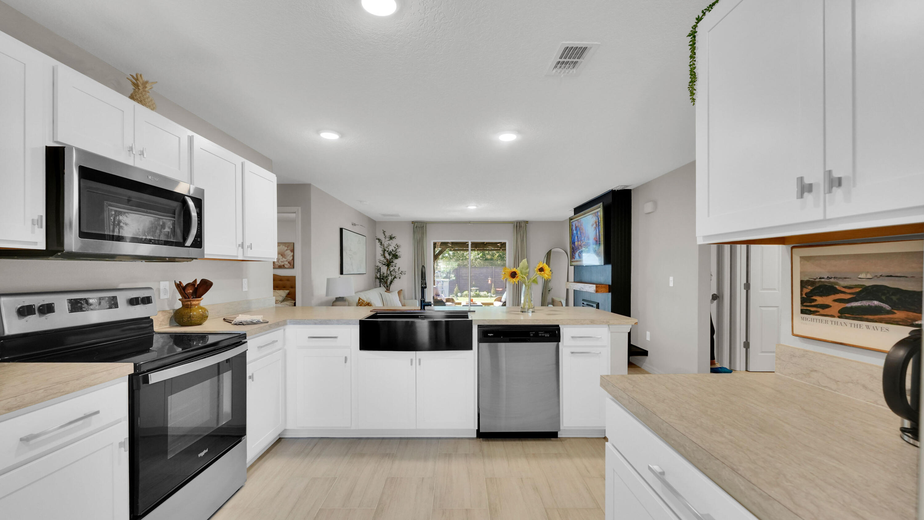 1382 Southwest Becker Road Port St. Lucie, FL 34953 - Photo 21 of 56 a kitchen with stainless steel appliances a stove top oven a sink a refrigerator white cabinets and wooden floor