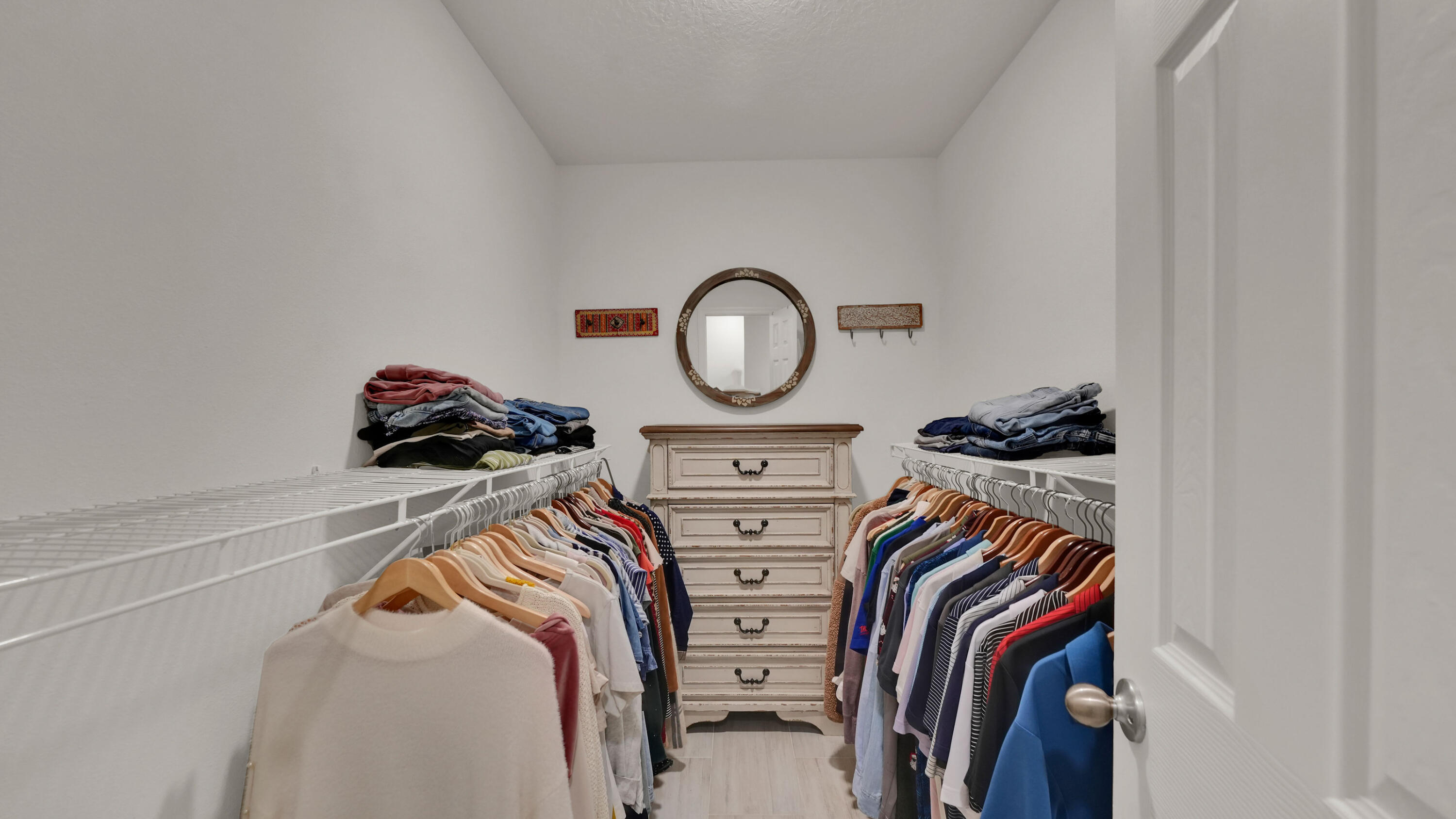 1382 Southwest Becker Road Port St. Lucie, FL 34953 - Photo 31 of 56 a view of walk in closet with clothes and shoes