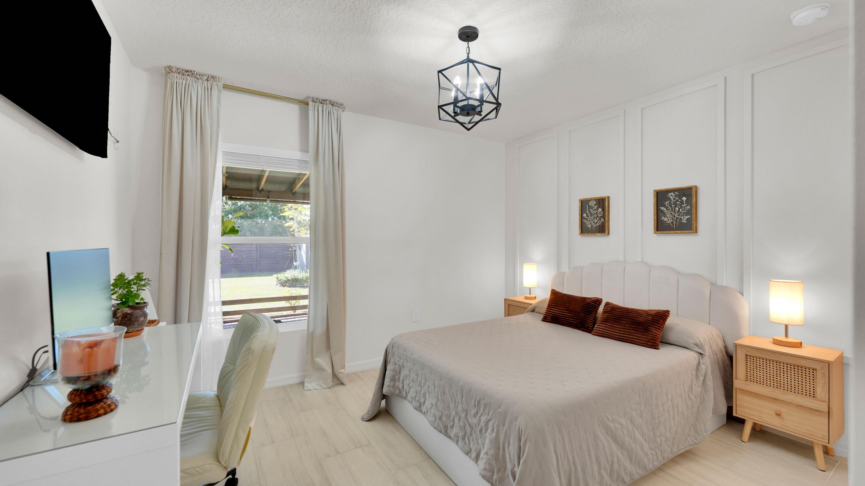 1382 Southwest Becker Road Port St. Lucie, FL 34953 - Photo 32 of 56 a bedroom with a bed and a chandelier