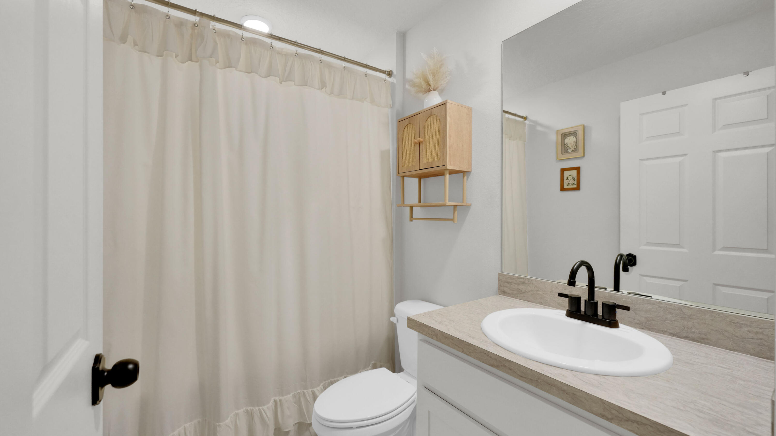 1382 Southwest Becker Road Port St. Lucie, FL 34953 - Photo 34 of 56 a bathroom with a sink a toilet and shower curtain