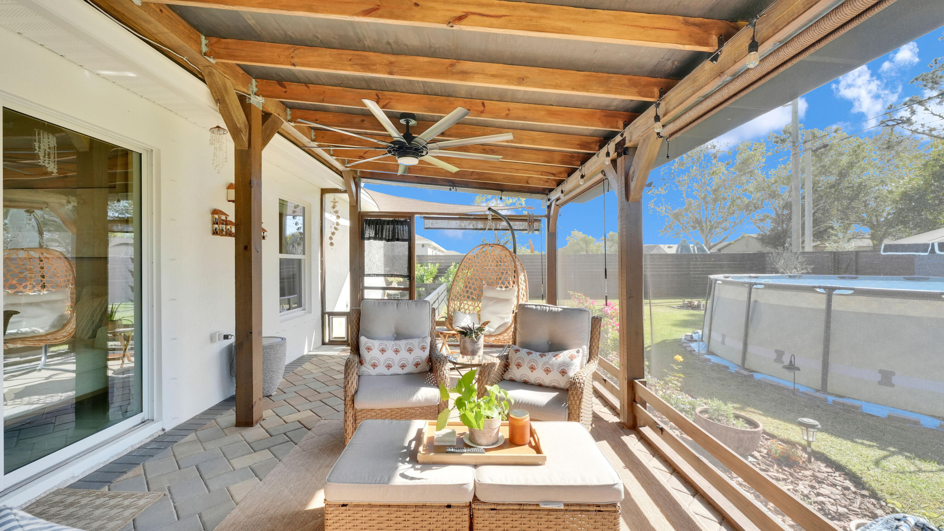 1382 Southwest Becker Road Port St. Lucie, FL 34953 - Photo 37 of 56 a view of a patio with table and chairs and wooden floor