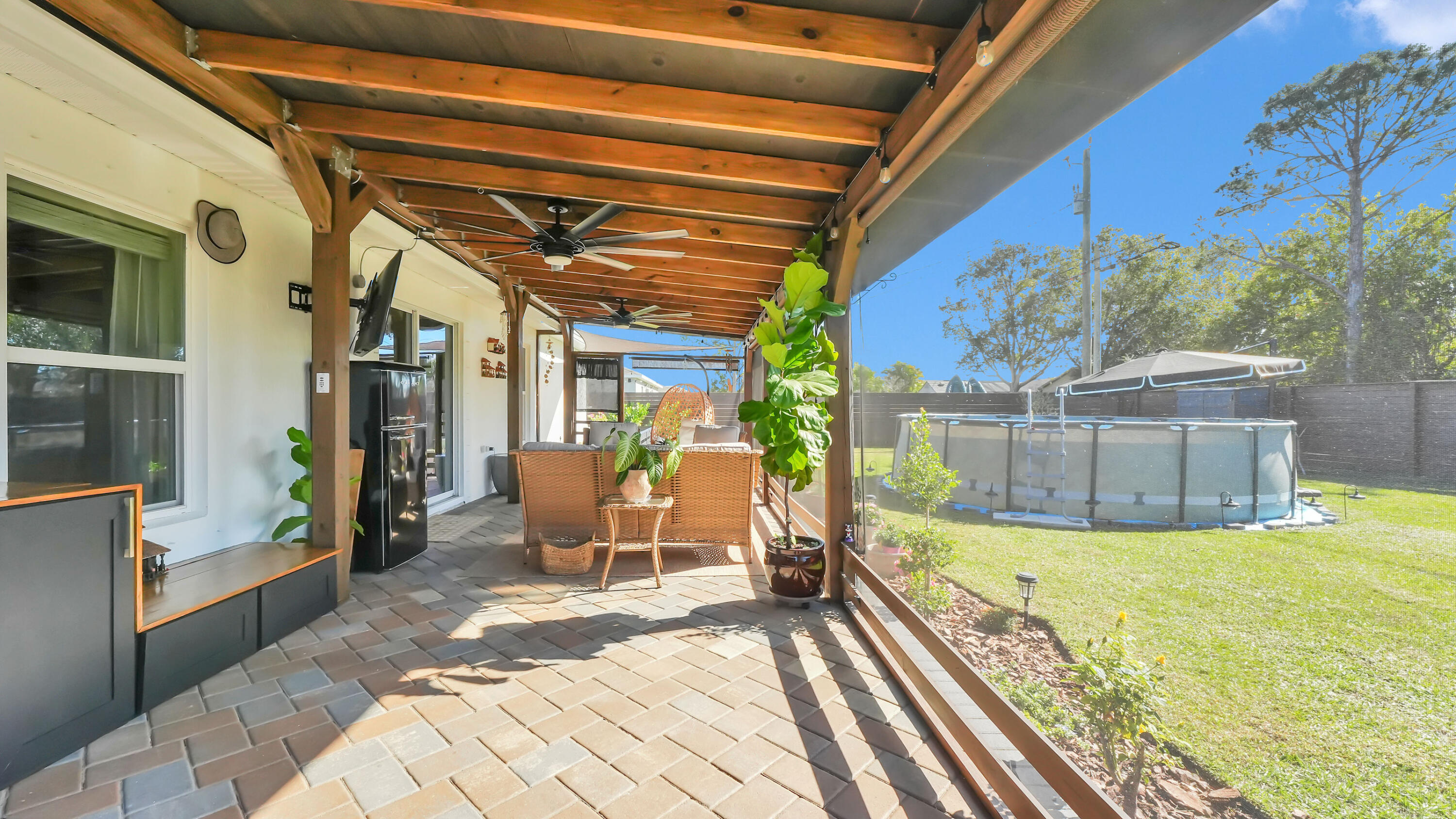 1382 Southwest Becker Road Port St. Lucie, FL 34953 - Photo 44 of 56 a view of a swimming pool with a patio