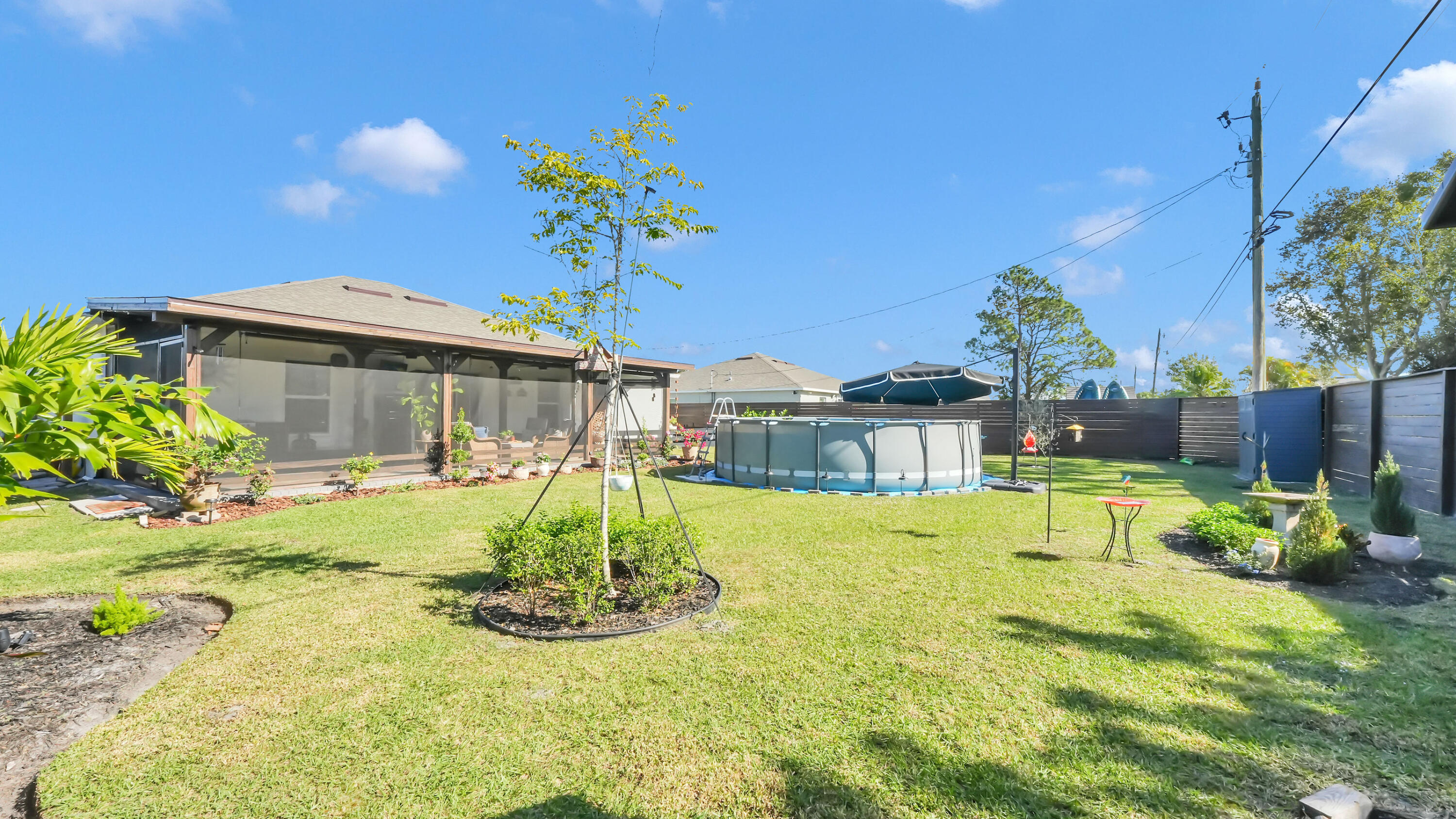 1382 Southwest Becker Road Port St. Lucie, FL 34953 - Photo 46 of 56 a view of an house with backyard porch and sitting area