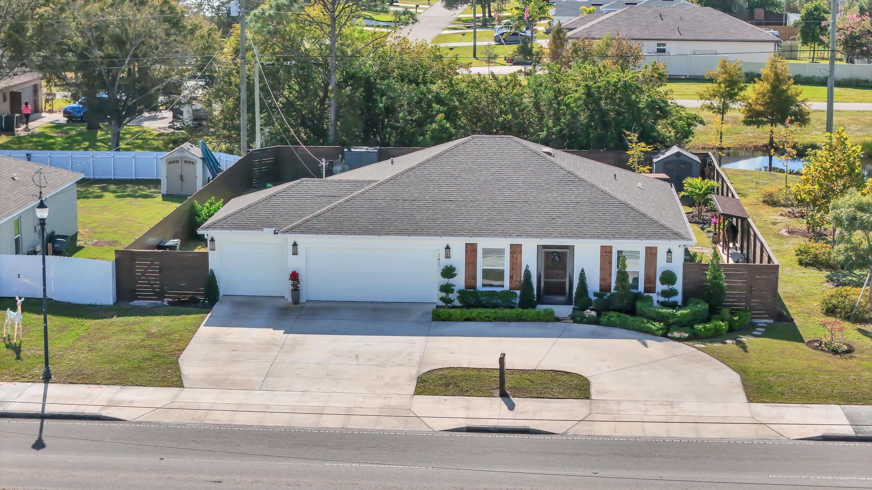 1382 Southwest Becker Road Port St. Lucie, FL 34953 - Photo 54 of 56 a front view of house with yard and green space