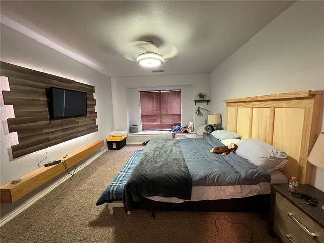 a bed room with furniture and a flat screen tv