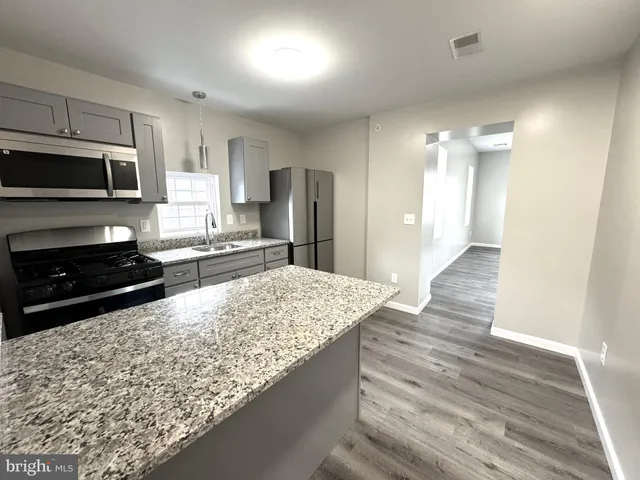 wooden floor in an empty room with a fireplace