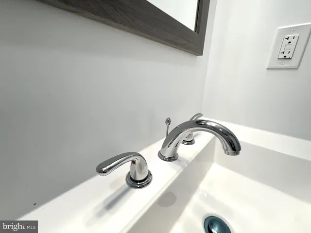 a view of a kitchen with stainless steel appliances wooden floor and a refrigerator