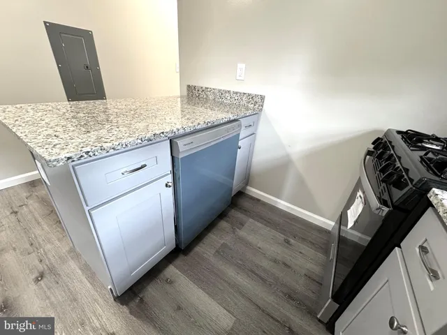 a view of a small space with wooden floor and windows