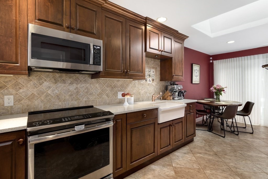 81 Algonquin Road, Unit 81 Newton, MA 02467 - Photo 13 of 40 a kitchen with stainless steel appliances a stove sink microwave and cabinets