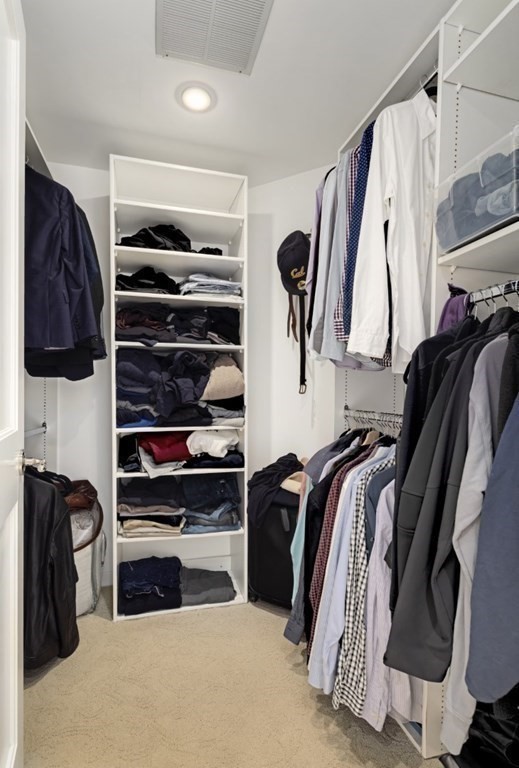 81 Algonquin Road, Unit 81 Newton, MA 02467 - Photo 20 of 40 a view of walk in closet with clothes and shoes