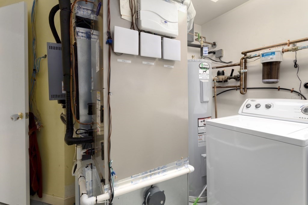 81 Algonquin Road, Unit 81 Newton, MA 02467 - Photo 31 of 40 a view of storage and utility room with a washer and dryer