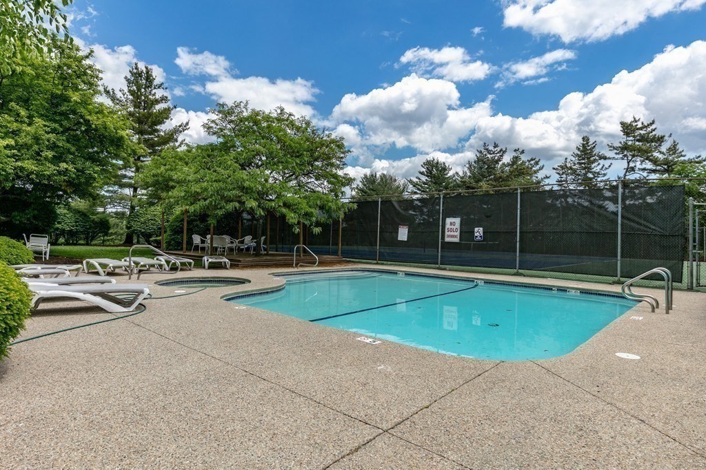 81 Algonquin Road, Unit 81 Newton, MA 02467 - Photo 39 of 40 a view of a swimming pool with a yard