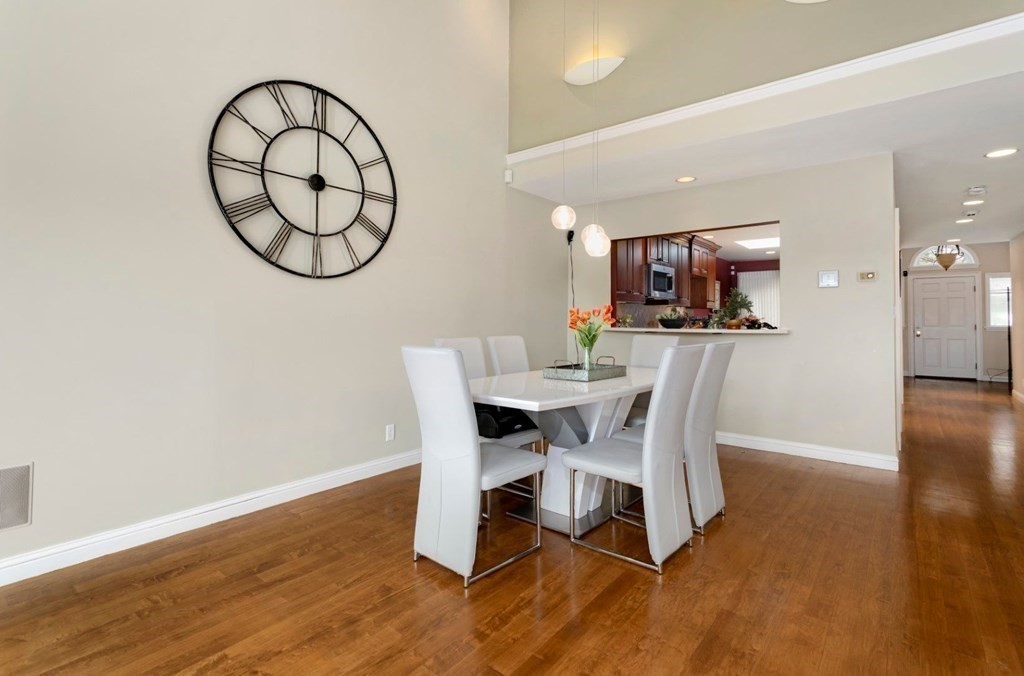 81 Algonquin Road, Unit 81 Newton, MA 02467 - Photo 7 of 40 a dining room with wooden floor a glass table and chairs