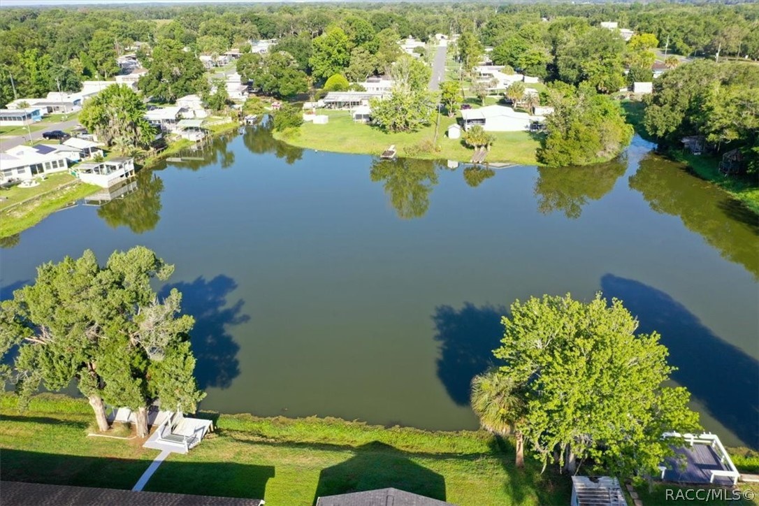 928 South Shad Terrace Inverness, FL 34450 - Photo 35 of 48 a view of a lake with lawn chairs
