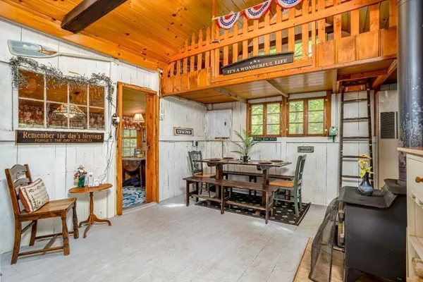 a view of a patio with a table chairs and a grill
