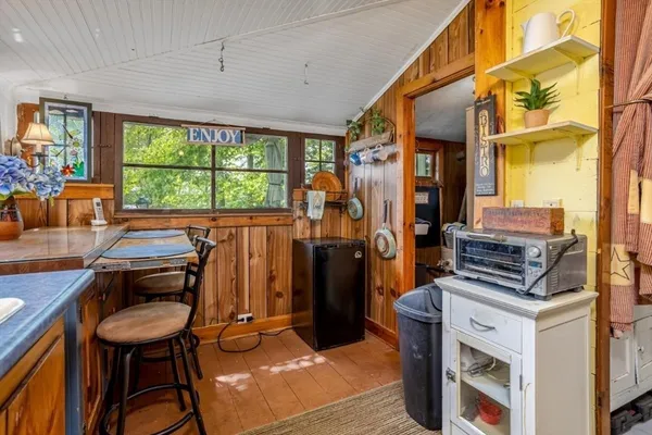 a backyard of a house with yard table and chairs