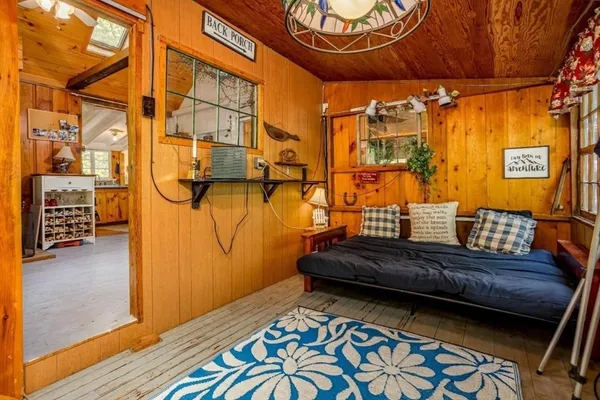 a balcony view with couple of chairs and wooden floor
