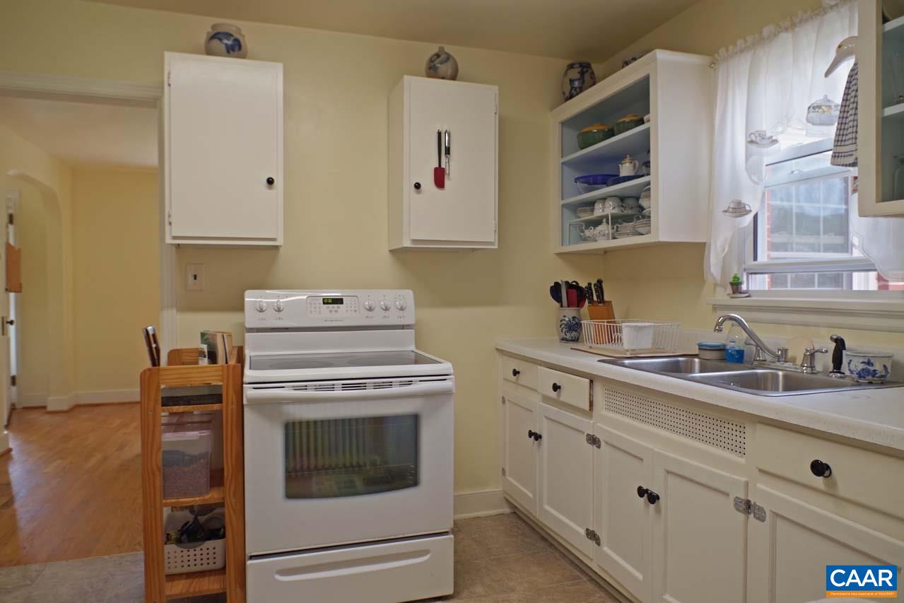 88 Court Street Lovingston, VA 22949 - Photo 14 of 44 a kitchen with cabinets stainless steel appliances a sink and wooden floor