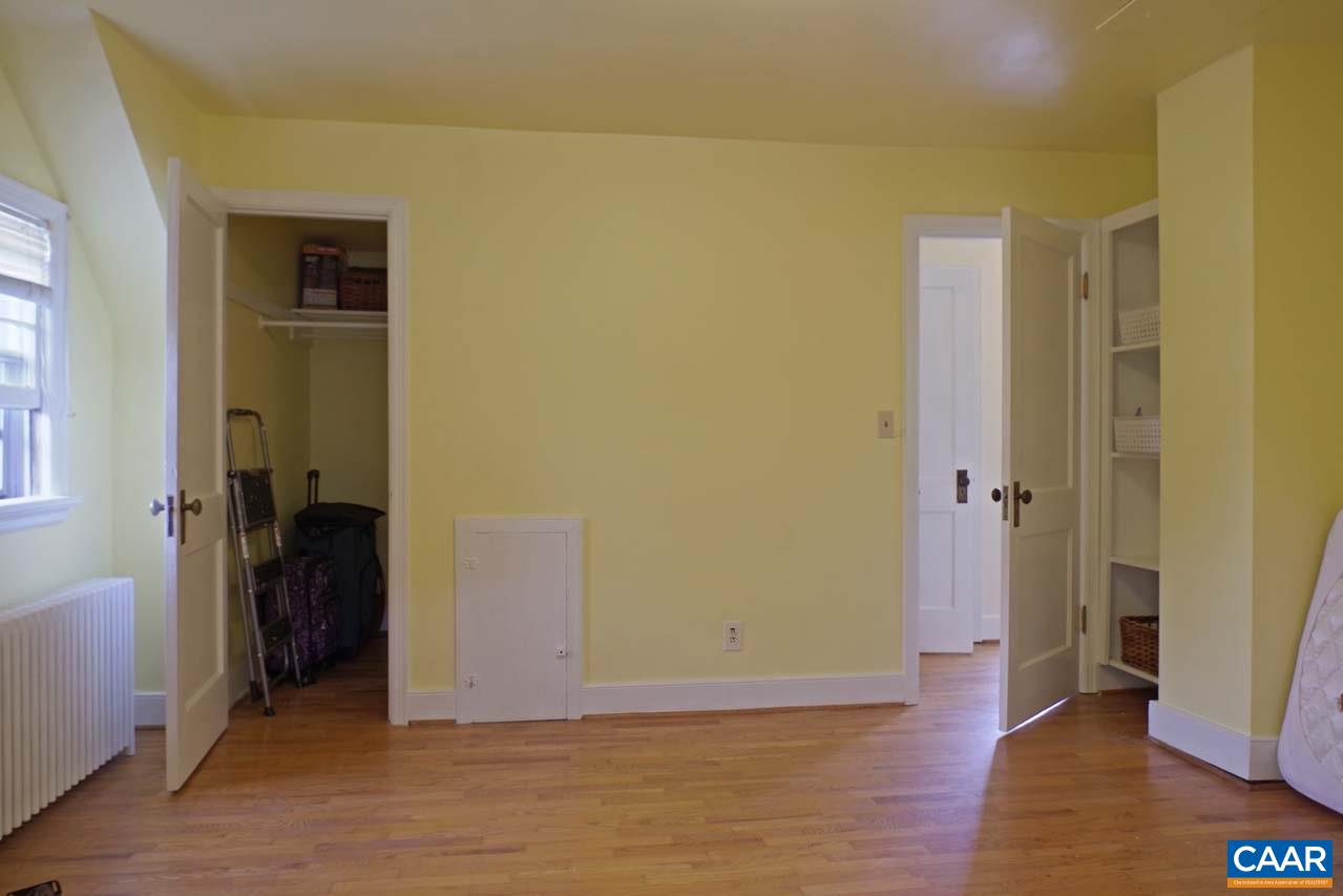 88 Court Street Lovingston, VA 22949 - Photo 30 of 44 a view of an empty room with wooden floor and a bathroom
