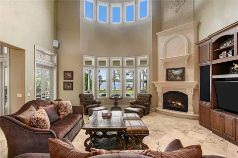 a kitchen with stainless steel appliances kitchen island granite countertop a refrigerator a stove a oven a sink with island and chairs