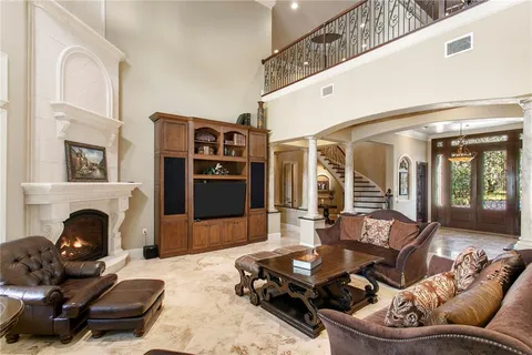 a large kitchen with granite countertop a sink and cabinets