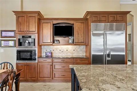 a spacious bedroom with a bed and a flat screen tv