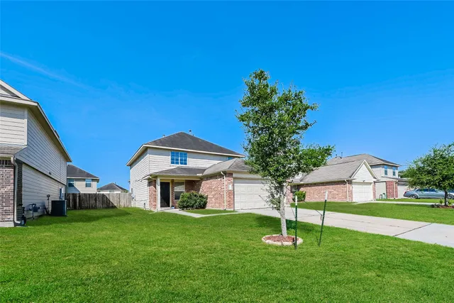 a front view of house with yard and green space