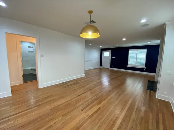 a view of a room with wooden floor and window