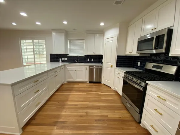 a kitchen that has a sink and a stove in it