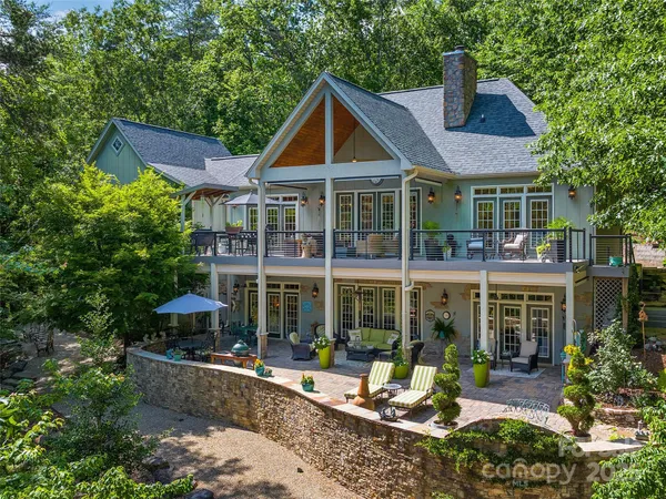 a view of a house with a yard and sitting area