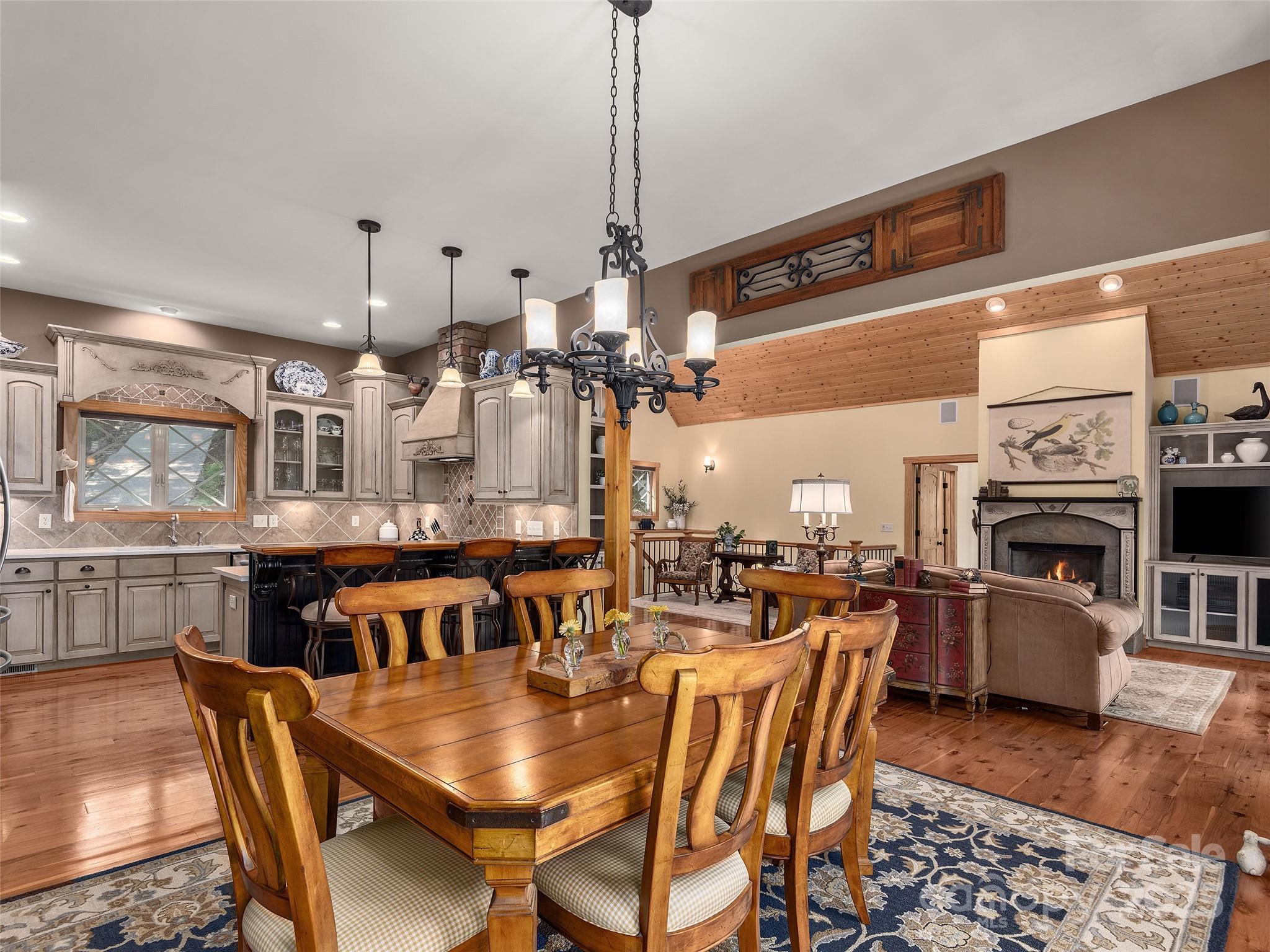 92 Island View Court Mill Spring, NC 28756 - Photo 12 of 48 a dining room with furniture a chandelier and wooden floor