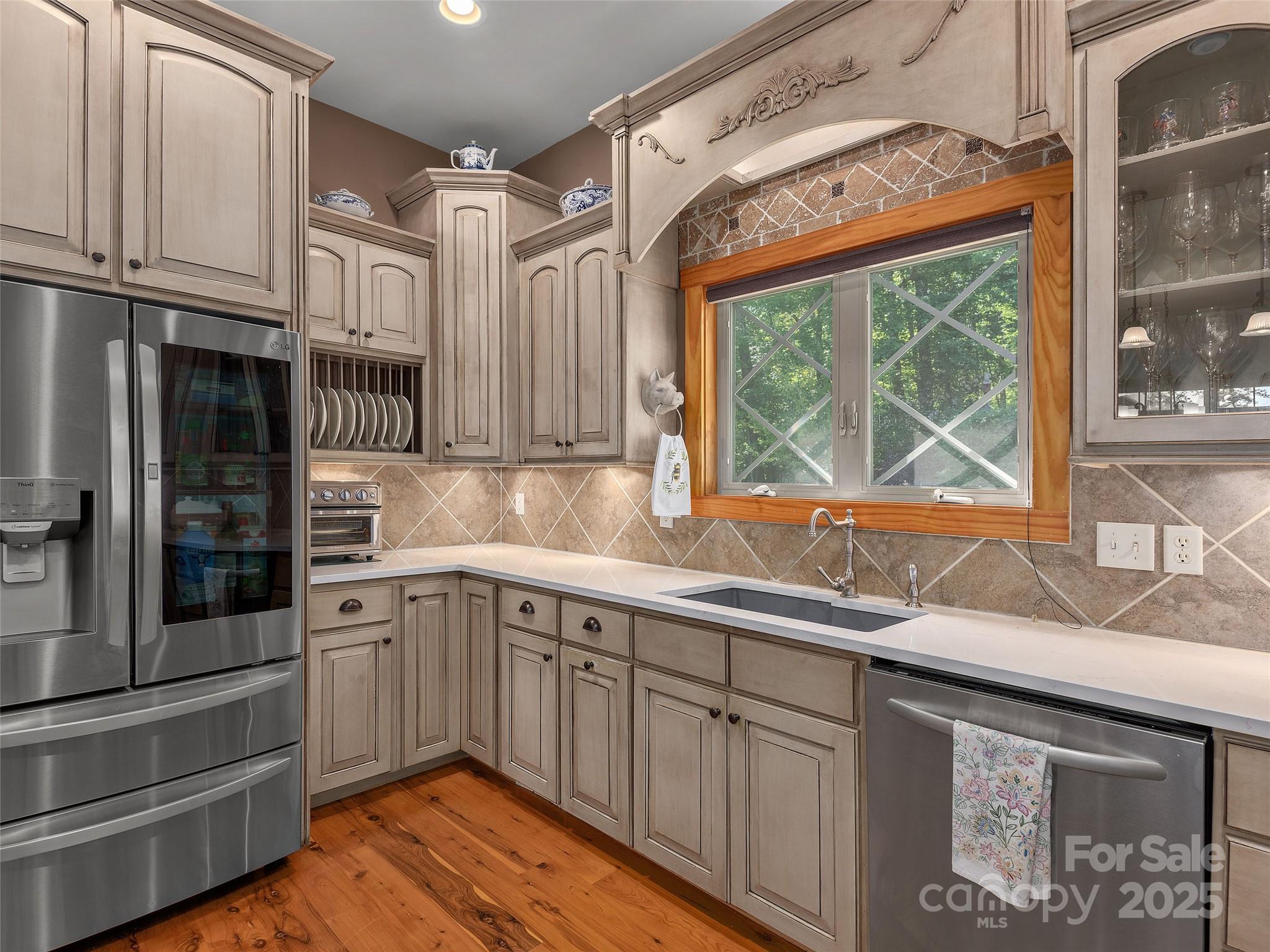92 Island View Court Mill Spring, NC 28756 - Photo 15 of 48 a kitchen with stainless steel appliances granite countertop a sink and cabinets with wooden floor